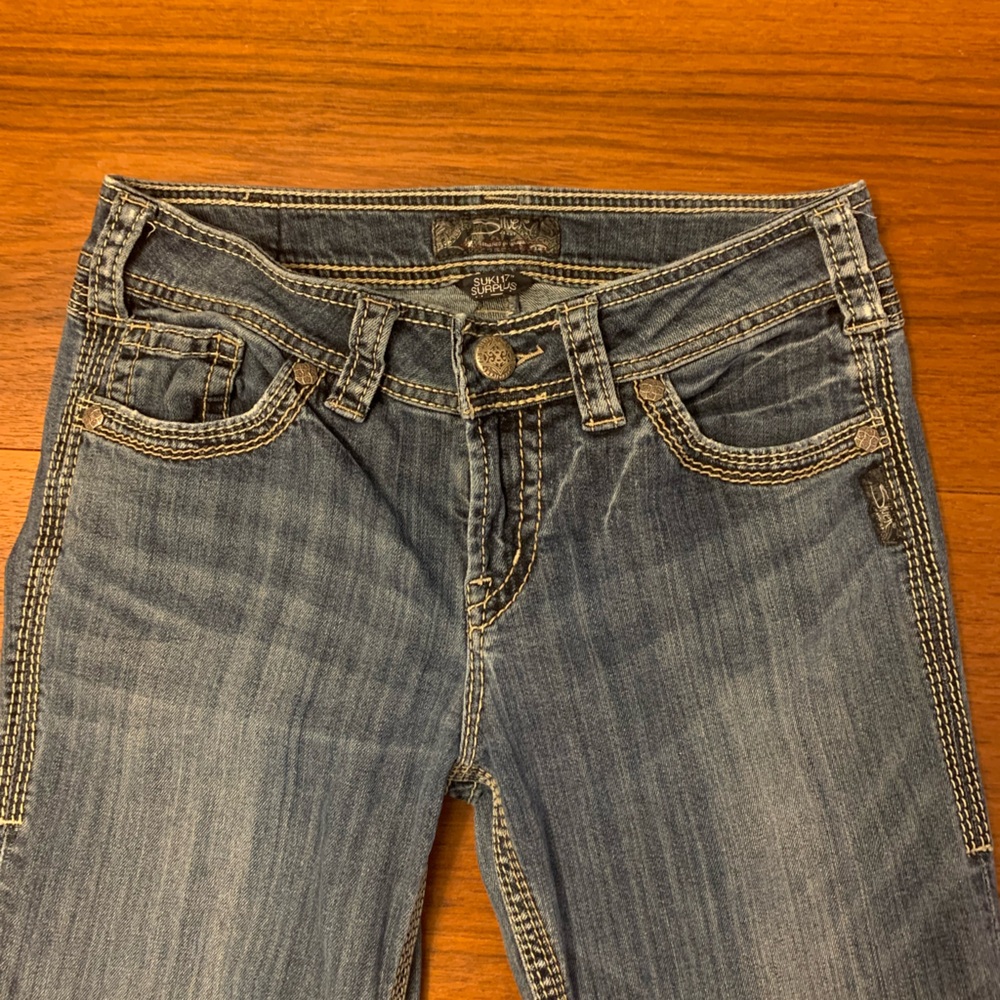 Silver low rise flare jeans.
